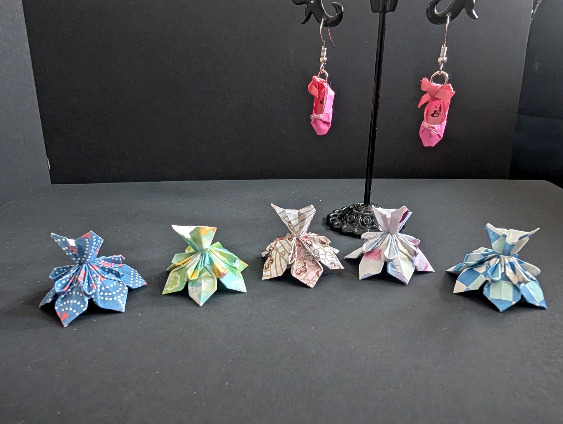 A line-up of colourful handmade folded origami forms